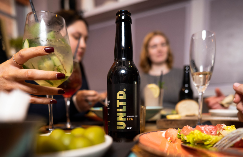 family cracking open a case of alcohol-free beer